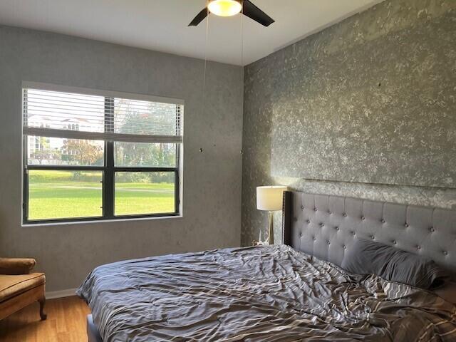 bedroom with hardwood / wood-style floors and ceiling fan