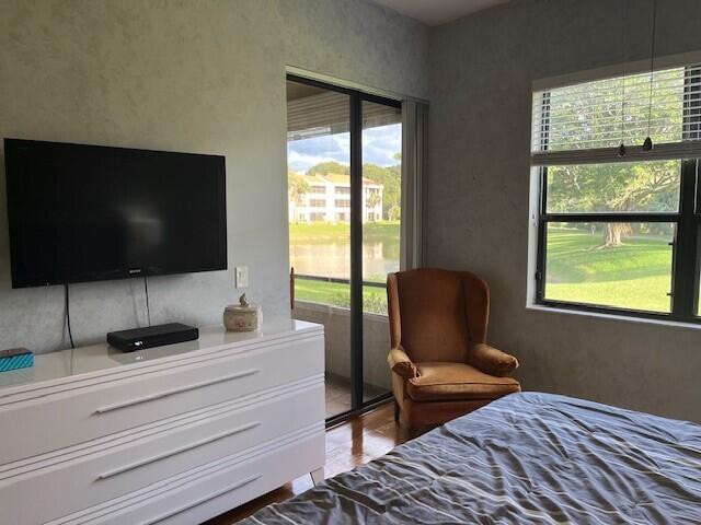 bedroom featuring hardwood / wood-style floors and multiple windows