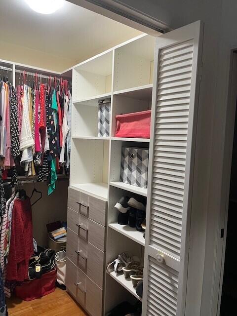 spacious closet featuring light hardwood / wood-style floors