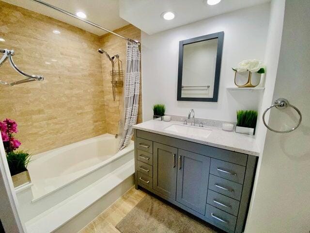 bathroom with vanity and shower / bath combo with shower curtain