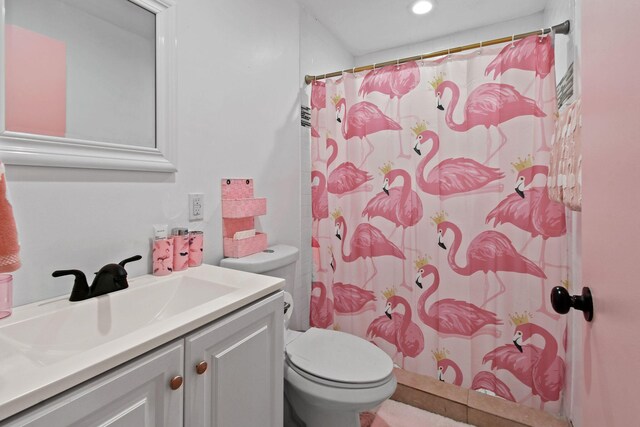 bathroom featuring vanity, a shower with curtain, and toilet