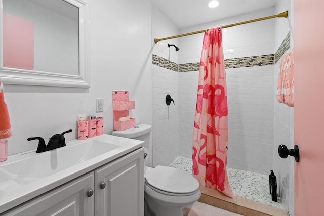 bathroom featuring vanity, curtained shower, and toilet