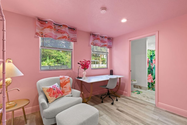 office area with light hardwood / wood-style floors