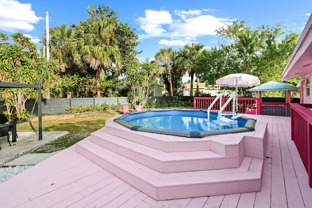 view of swimming pool with a wooden deck