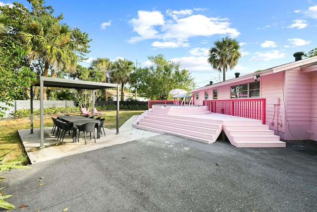 view of community featuring a wooden deck and a patio area