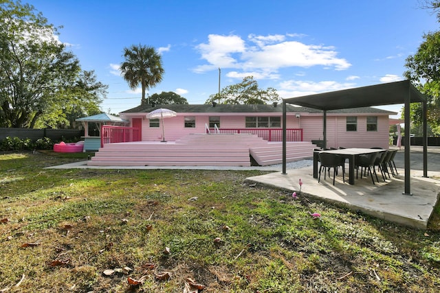 back of house featuring a yard and a deck