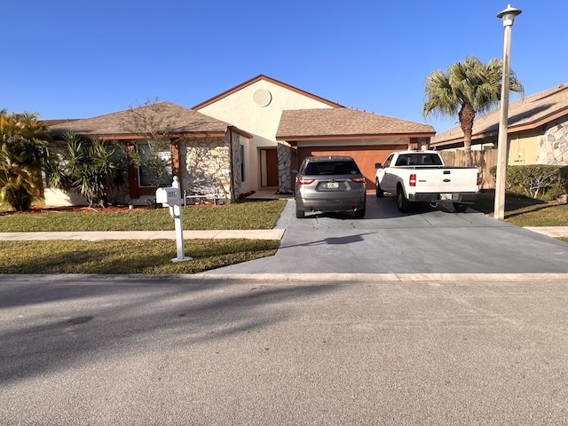 view of front of home with a garage and a front yard