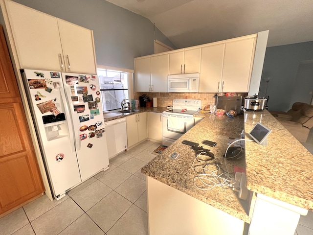 kitchen with white appliances, kitchen peninsula, sink, and light tile patterned floors