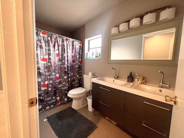 bathroom featuring vanity, tile patterned flooring, and toilet