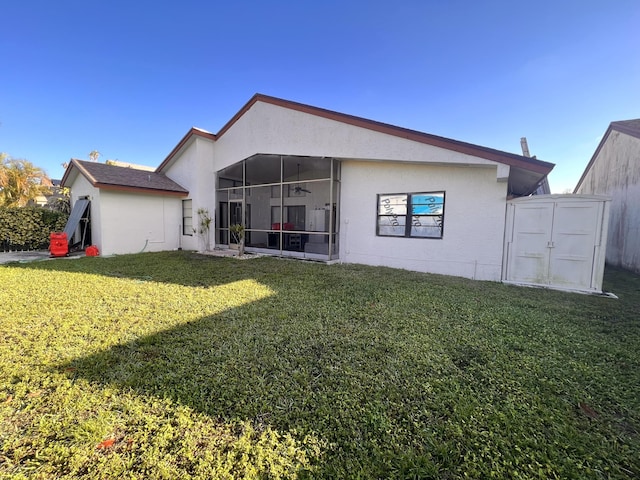 back of property with a sunroom and a yard