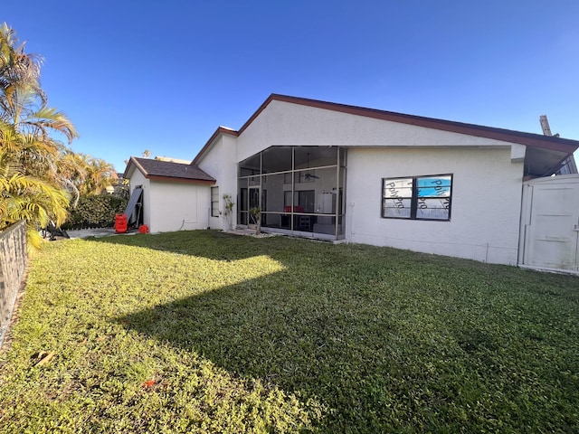 back of property featuring a lawn