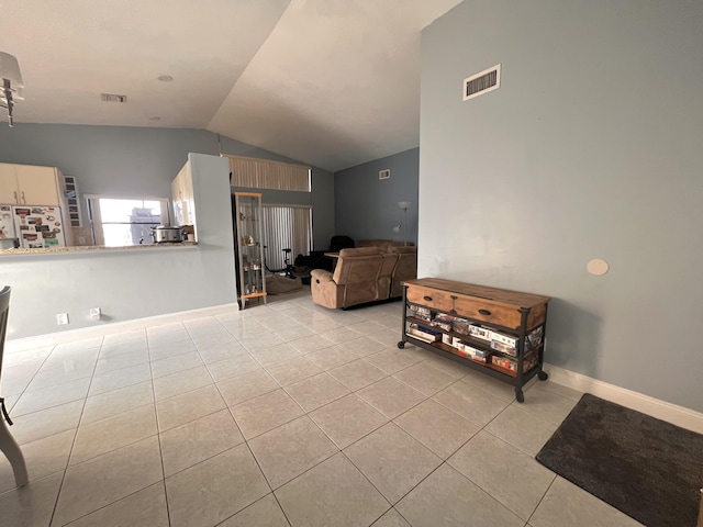 tiled living room with vaulted ceiling