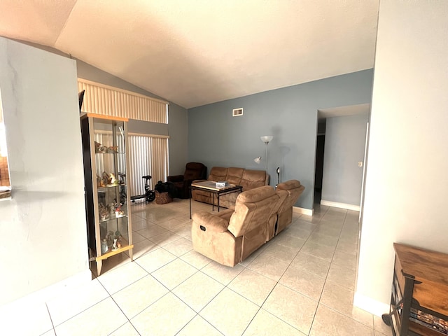 tiled living room featuring vaulted ceiling