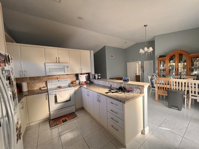 kitchen with lofted ceiling, white appliances, tasteful backsplash, light tile patterned flooring, and kitchen peninsula