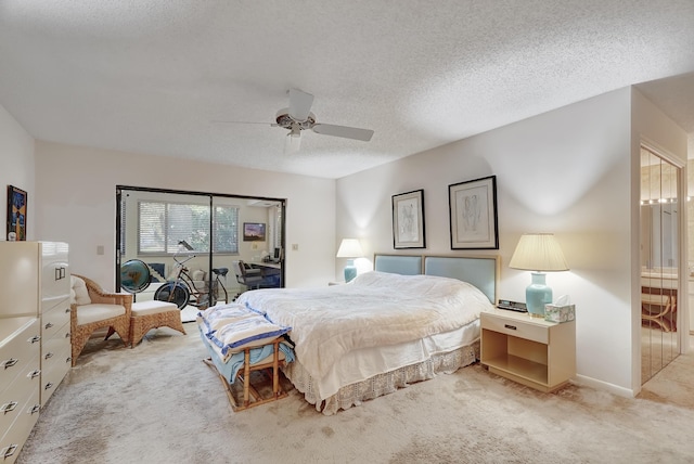 carpeted bedroom with ceiling fan, a textured ceiling, and access to outside