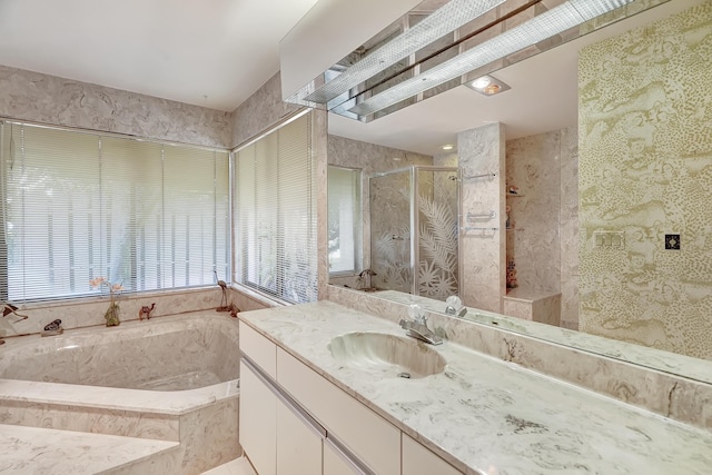 bathroom featuring vanity and separate shower and tub