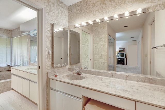 bathroom featuring tile patterned floors, vanity, and a bathing tub