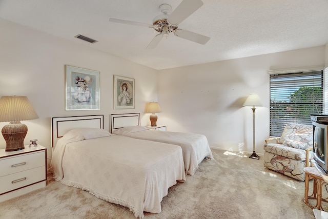 bedroom featuring ceiling fan and light colored carpet