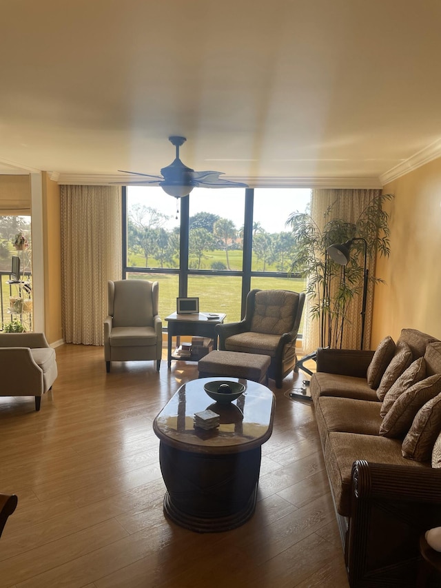 living room featuring expansive windows, ornamental molding, ceiling fan, and dark hardwood / wood-style flooring