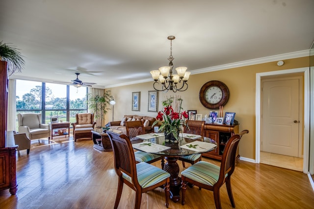 dining area with crown molding, ceiling fan with notable chandelier, and light wood-type flooring