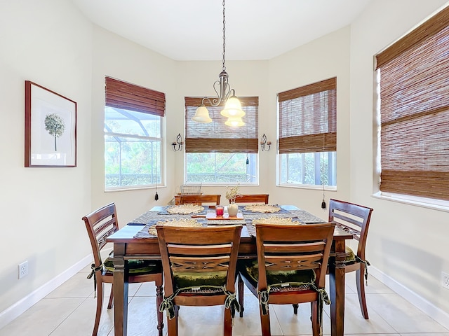 tiled dining space featuring a wealth of natural light and a chandelier