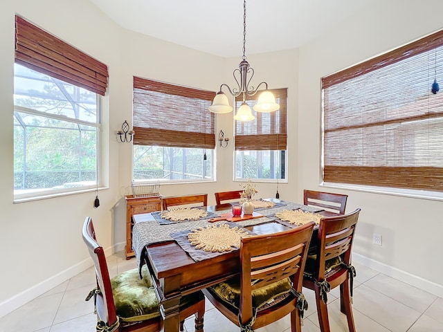 dining room with light tile patterned flooring and a chandelier