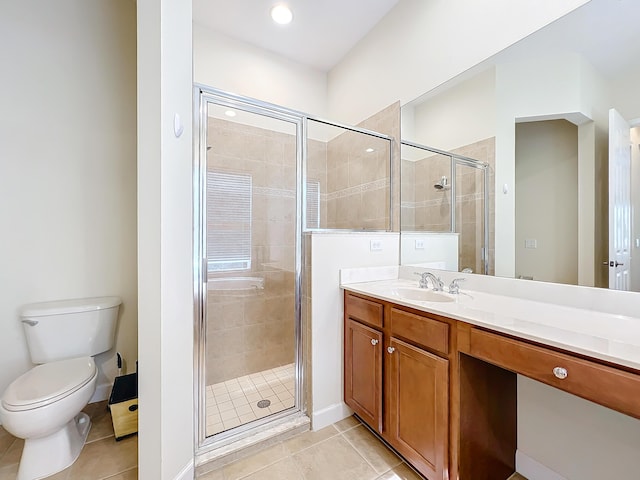 bathroom featuring vanity, tile patterned floors, toilet, and walk in shower