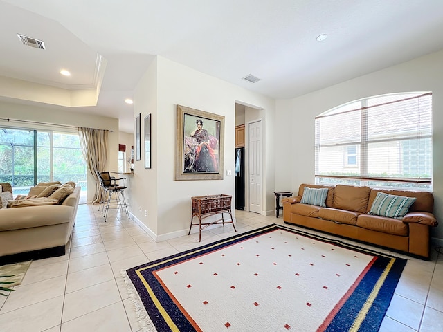 tiled living room with a raised ceiling