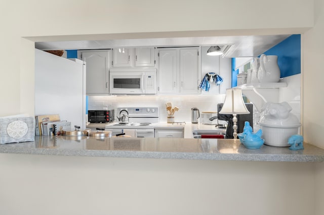 kitchen featuring white cabinetry, sink, white appliances, and tasteful backsplash