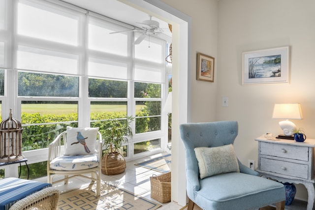 sitting room with light tile patterned floors and ceiling fan