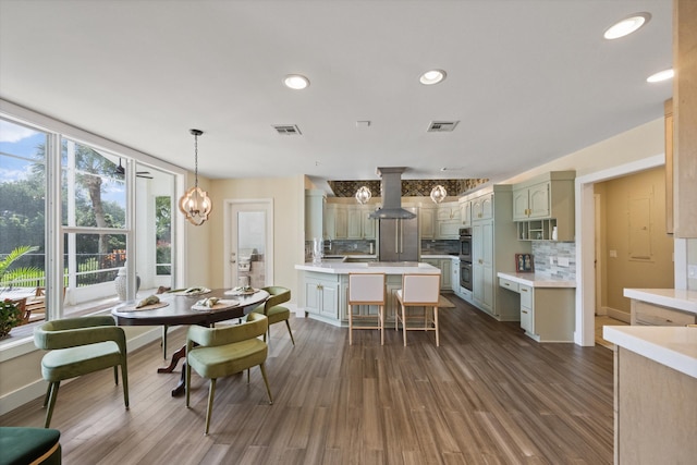 dining space with dark wood-type flooring and a notable chandelier