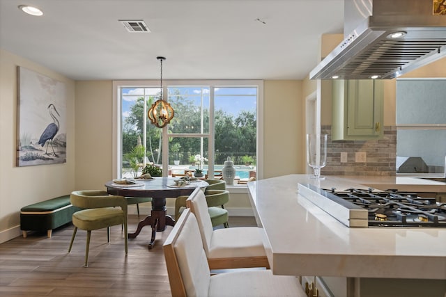 dining area featuring an inviting chandelier and hardwood / wood-style floors