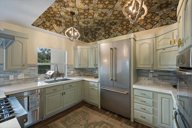 kitchen with built in refrigerator, dark hardwood / wood-style flooring, sink, and decorative backsplash