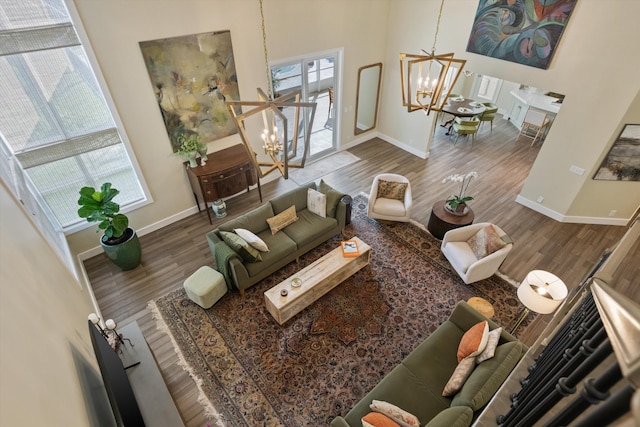 living room featuring an inviting chandelier and hardwood / wood-style flooring