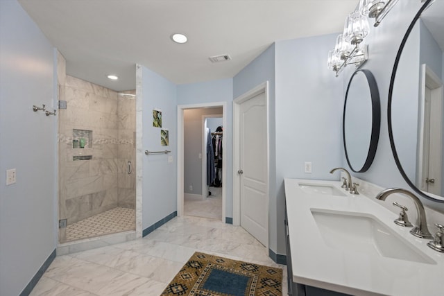 bathroom with vanity and a shower with shower door