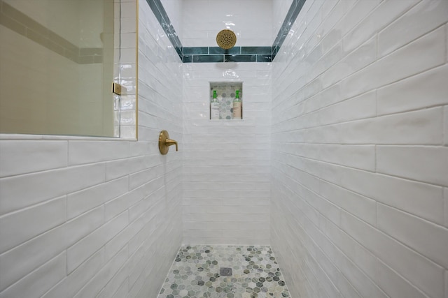 bathroom with tiled shower