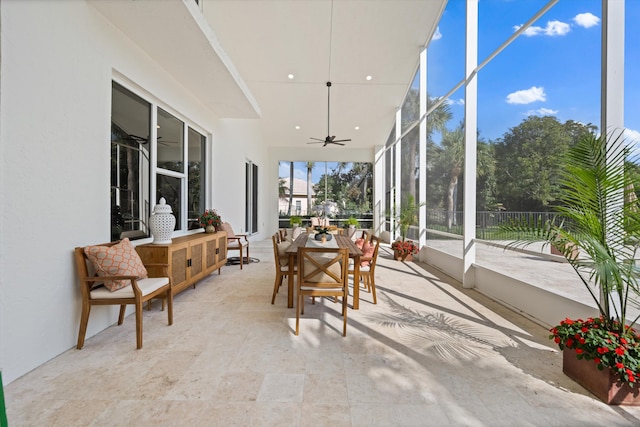 sunroom featuring ceiling fan