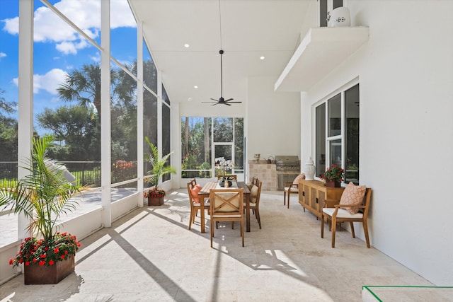 sunroom / solarium featuring ceiling fan and a healthy amount of sunlight