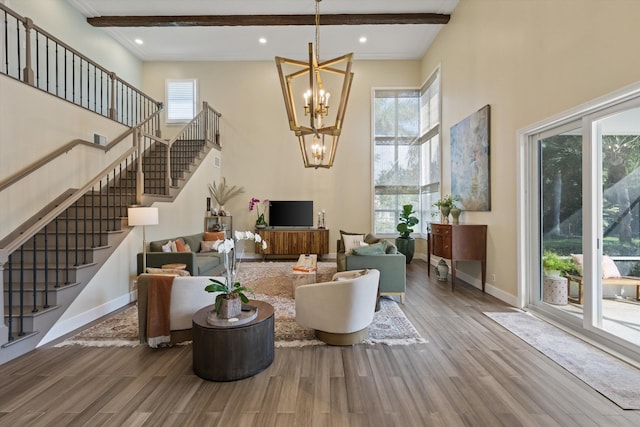 living room with wood-type flooring, a wealth of natural light, and a chandelier