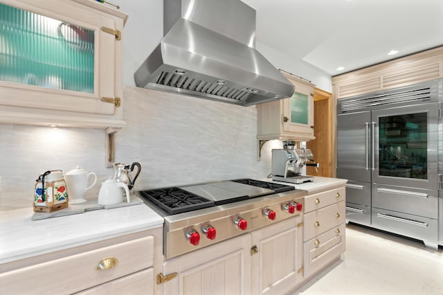 kitchen featuring island range hood, stainless steel appliances, decorative backsplash, and light brown cabinets