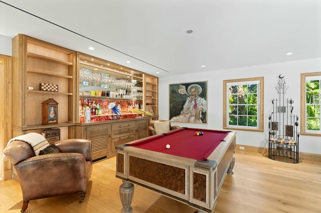 playroom featuring indoor bar, pool table, light hardwood / wood-style flooring, and built in features