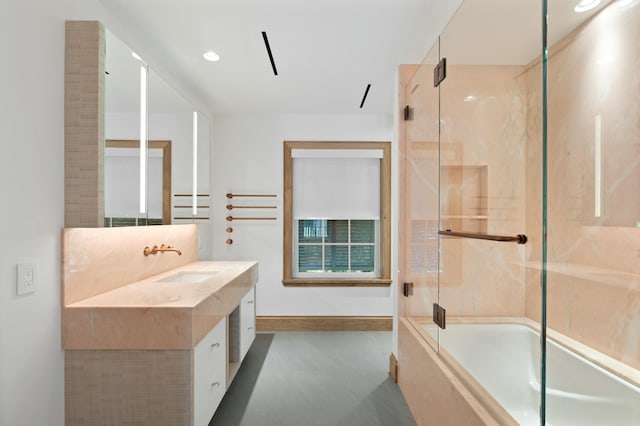 bathroom with vanity and shower / bath combination with glass door