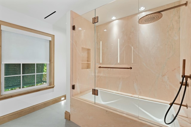 bathroom with bath / shower combo with glass door