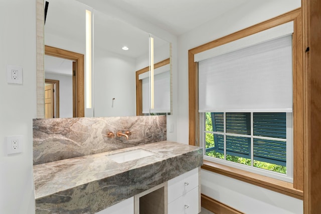 bathroom featuring vanity and decorative backsplash