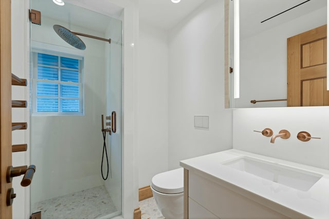 bathroom with a shower with door, vanity, and toilet