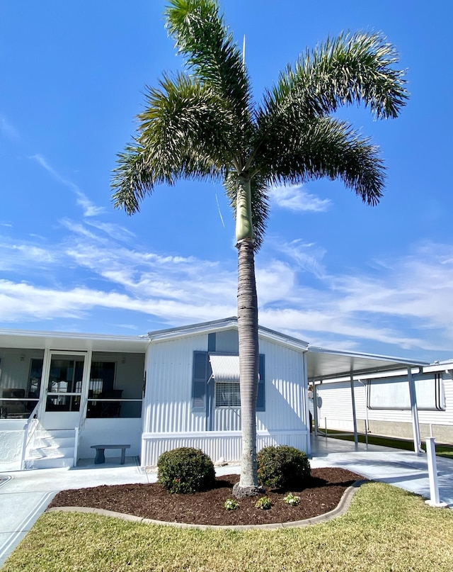 view of front facade featuring a carport and a sunroom