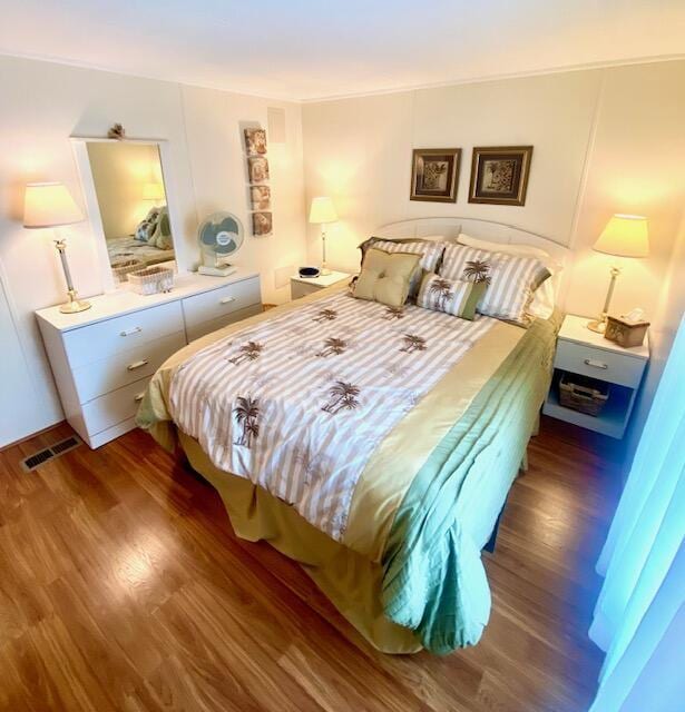 bedroom with dark hardwood / wood-style floors