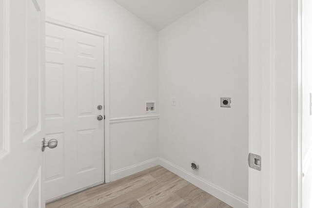 clothes washing area featuring electric dryer hookup, washer hookup, and light hardwood / wood-style floors