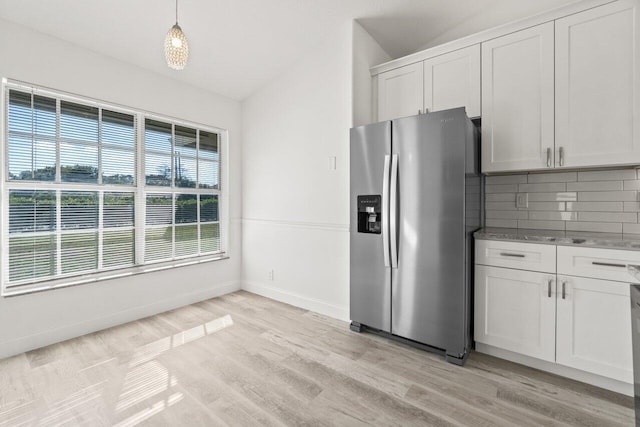 kitchen featuring light hardwood / wood-style flooring, white cabinetry, stainless steel refrigerator with ice dispenser, tasteful backsplash, and decorative light fixtures