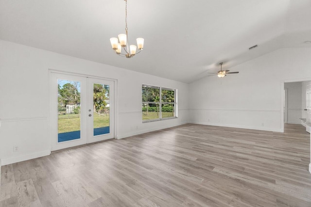 unfurnished living room with french doors, vaulted ceiling, ceiling fan with notable chandelier, and light hardwood / wood-style flooring